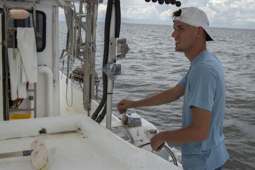 Tommy Olander Jr. on Aug. 9 drives his family's shrimping boat in Vermillion Bay off the Louisiana coast near Jeanerette. Vermillion Bay, inland of the oxygen-deprived “dead zone,” was expected soon to be full of shrimp boats for the opening of the fall season as trawlers compete in the same inland waters for a shrinking pool of shrimp. (Photo by John Steppe)